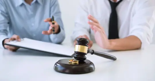 people signing a document and arguing